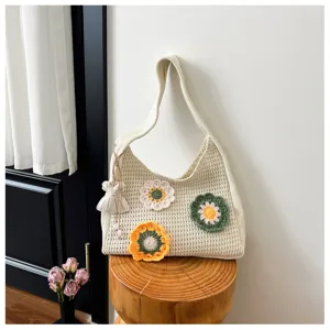 Crochet knit shoulder bag with cute handmade floral decor, perfect stylish summer vacation accessory.