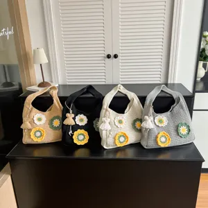 Chic knit tote bag for women featuring handmade crochet flowers and cute pendant.