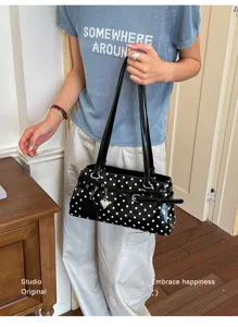 Stylish minimalist polka dot handbag for women, chic commuter shoulder bag with cute heart charm.