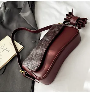 Burgundy embossed shoulder bag detail, chic French style design, elegant daily fashion accessory.