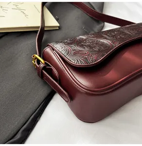 Elegant burgundy embossed shoulder bag for women, chic vintage crossbody bag detail.