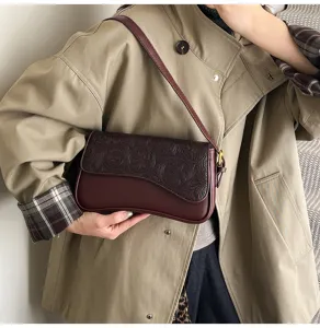Chic French niche women's shoulder bag with embossed flap detail, elegant design for daily wear.