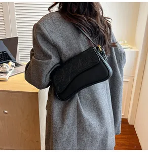 Black stylish shoulder crossbody bag for women, chic embossed flap design, daily fashion look.