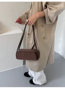 Stylish minimalist underarm shoulder bag for women, solid color casual commuter handbag.