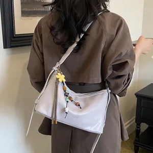 Chic autumn women shoulder bag, versatile soft leather hobo bag with cute charm pendant.