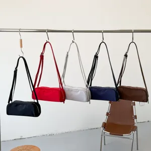 Stylish minimalist cylindrical shoulder bag, trendy solid color bag for daily commute.