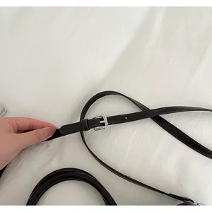 Brown PU leather shoulder bag strap detail with silver metal buckle closeup shot