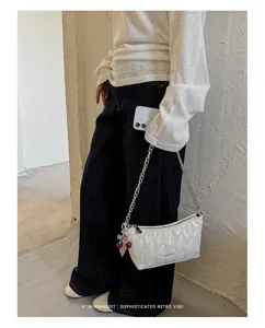 White quilted baguette shoulder bag with chain strap and cute cherry charm for women summer.