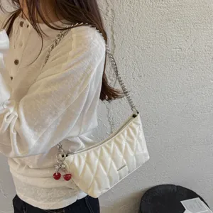 Chic white quilted baguette shoulder bag with silver chain strap and sweet cherry charm for women.