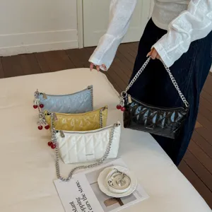 Stylish quilted shoulder bag with chain strap and cute cherry pendant, perfect for daily use.