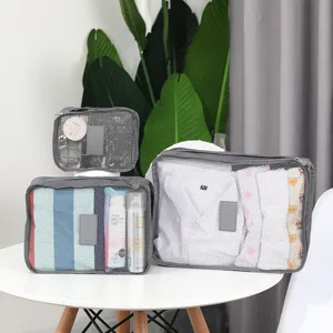 Gray mesh travel storage bags set packing cubes for luggage clothing organization accessories.