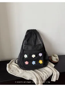 Black mesh drawstring backpack with colorful crochet flowers for daily student commuter.