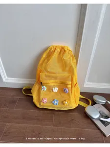 Yellow mesh drawstring backpack for women, featuring cute crochet floral accents and pocket.