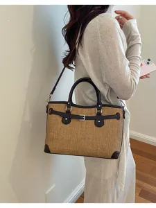 Stylish straw handbag for women, chic patchwork shoulder bag with top handle and belt design.