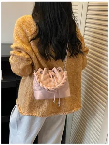 Chic women's quilted bucket shoulder bag, minimalist crossbody handbag with handle for summer.