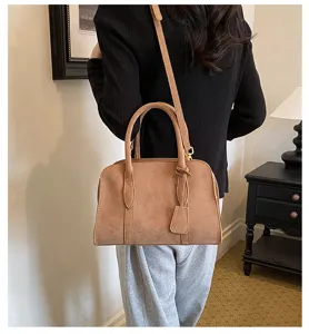 Retro suede Boston shoulder bag for women, casual vintage handbag with top handle and strap.
