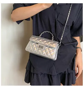 Silver quilted chain crossbody bag for women, stylish metallic shoulder handbag with turn lock.