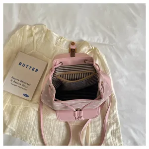 Pink polka dot backpack detail showing interior striped lining and drawstring closure design.