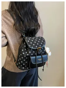 Detailed view of women casual polka dot backpack worn on back, showing stylish design.