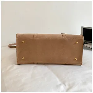 Retro suede Boston bag bottom detail showing sturdy metal feet and classic vintage design.