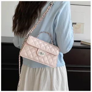 Pink quilted shoulder bag detail showcasing metallic chain strap and twist-lock closure design.