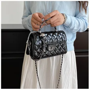 Black quilted chain handbag detail, elegant shoulder crossbody bag design for summer fashion wear.