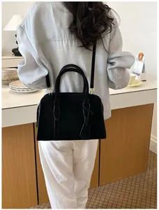 Vintage black suede handbag for women, retro shoulder bag and stylish crossbody Boston bag.