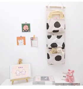 Canvas bedside hanging storage bag with multi pockets for dorm wall and door organization.