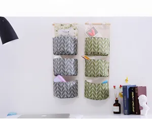 Cotton linen hanging storage bag wall mounted 3 pocket dorm organizer for home decor.
