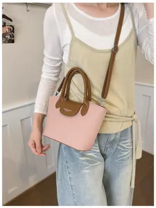 Korean minimalist dumpling handbag with contrast handle and adjustable shoulder strap for women.