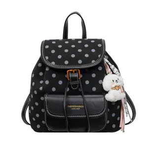 Black polka dot backpack women casual travel school bag with cute plush dog pendant.