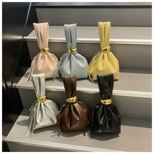 Detailansicht stilvoller Plissee-Handtaschen mit metallischen Ringverschlüssen im Set.