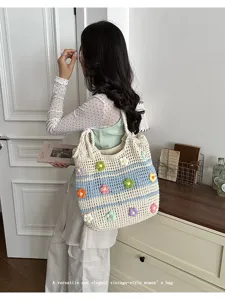 Detailed view of the vintage crochet tote bag featuring colorful handmade floral embroidery.
