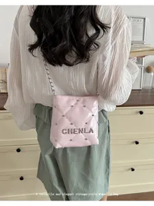 Versatile pink quilted shoulder bag for women, featuring metal studs and elegant chain strap.