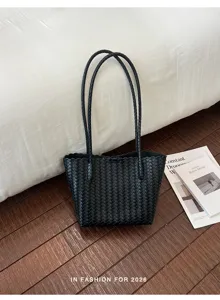 Black woven tote bag for women, stylish minimalist handbag with dual top handles.