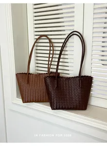 Detailed view of stylish woven leather tote shoulder bags in rich brown and dark brown.
