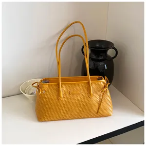 Bolso de hombro trenzado amarillo para mujer, elegante bolso de mano con asas y cordones.