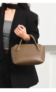 Detail view of a stylish brown women commuter handbag, showcasing premium leather texture and shape.