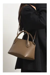 Retro brown commuting handbag and shoulder crossbody bag, elegant everyday style detail view.
