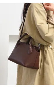Retro dark brown commuting shoulder bag detail, stylish women crossbody handbag lifestyle view.
