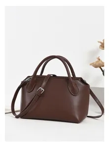 Detailed view of the brown leather shoulder bag, showcasing fine stitching and hardware.