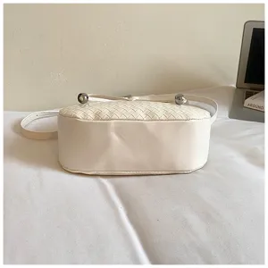 White woven leather hobo shoulder bag with chic metal ball accents, elegant crossbody.
