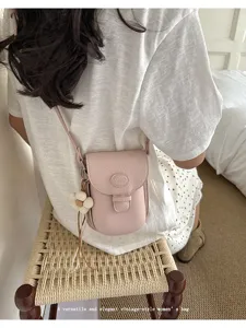 Minimalist pink crossbody bag for women, cute vintage shoulder bag with flower charm.