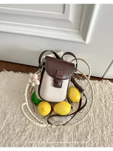 Chic vintage mini crossbody bag for women, stylish two-tone shoulder bag with cute lemon decor.