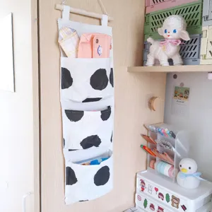 Cute bedside fabric hanging storage bag with multi-layer pockets for dormitory organization.