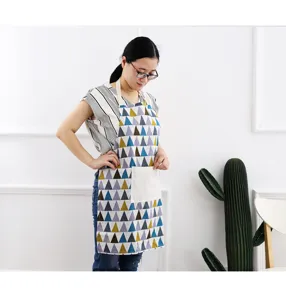 Detailed view of geometric triangle cotton linen apron with front pocket for kitchen cooking.
