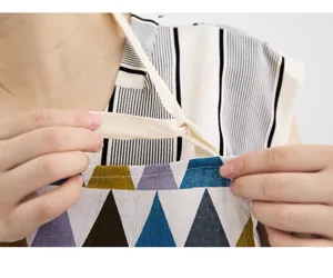 Cotton linen apron detail shot showing adjustable straps and stylish geometric pattern.