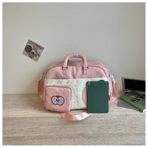 Detailed close-up view of pink starry travel duffel bag with front pocket and shoulder strap.