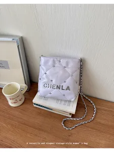 Versatile light purple quilted crossbody bag with chain strap and elegant metallic letter details.