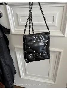 Elegant black quilted leather shoulder bag with metal chain strap and rhinestones for women.